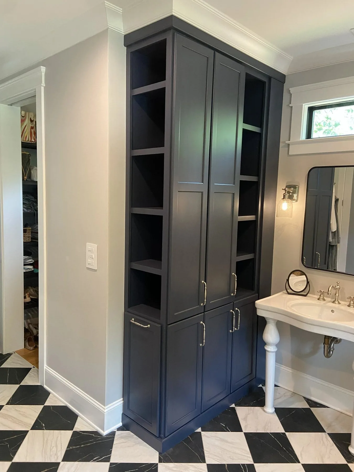 Tall custom cabinet tower with open shelving in a Wilmington bathroom