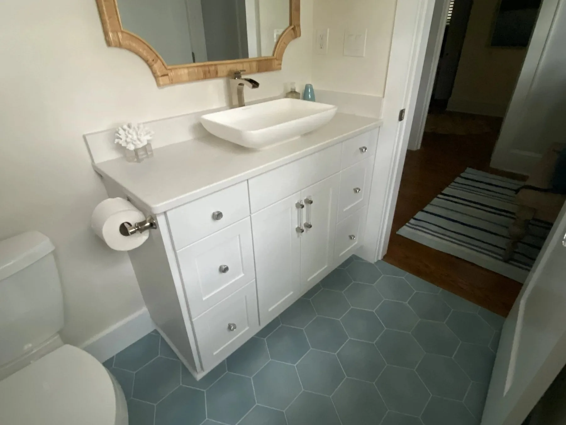 Custom bathroom vanity with a vessel sink and hexagon tile floor